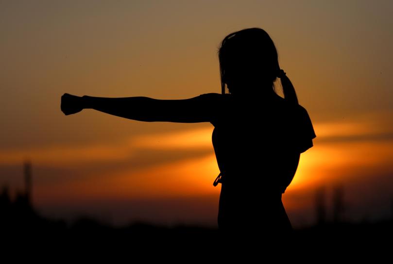 woman silhouette fist